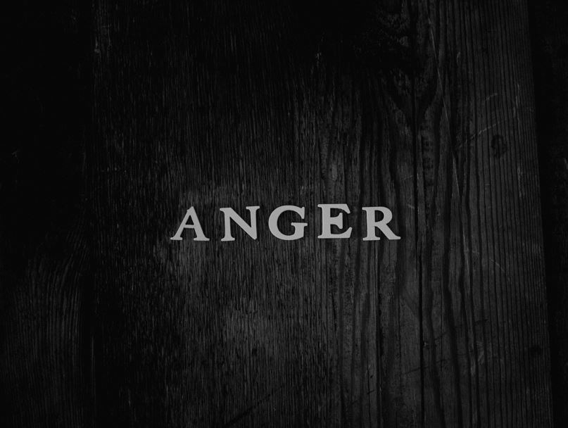 Word "anger" spelled out on wood