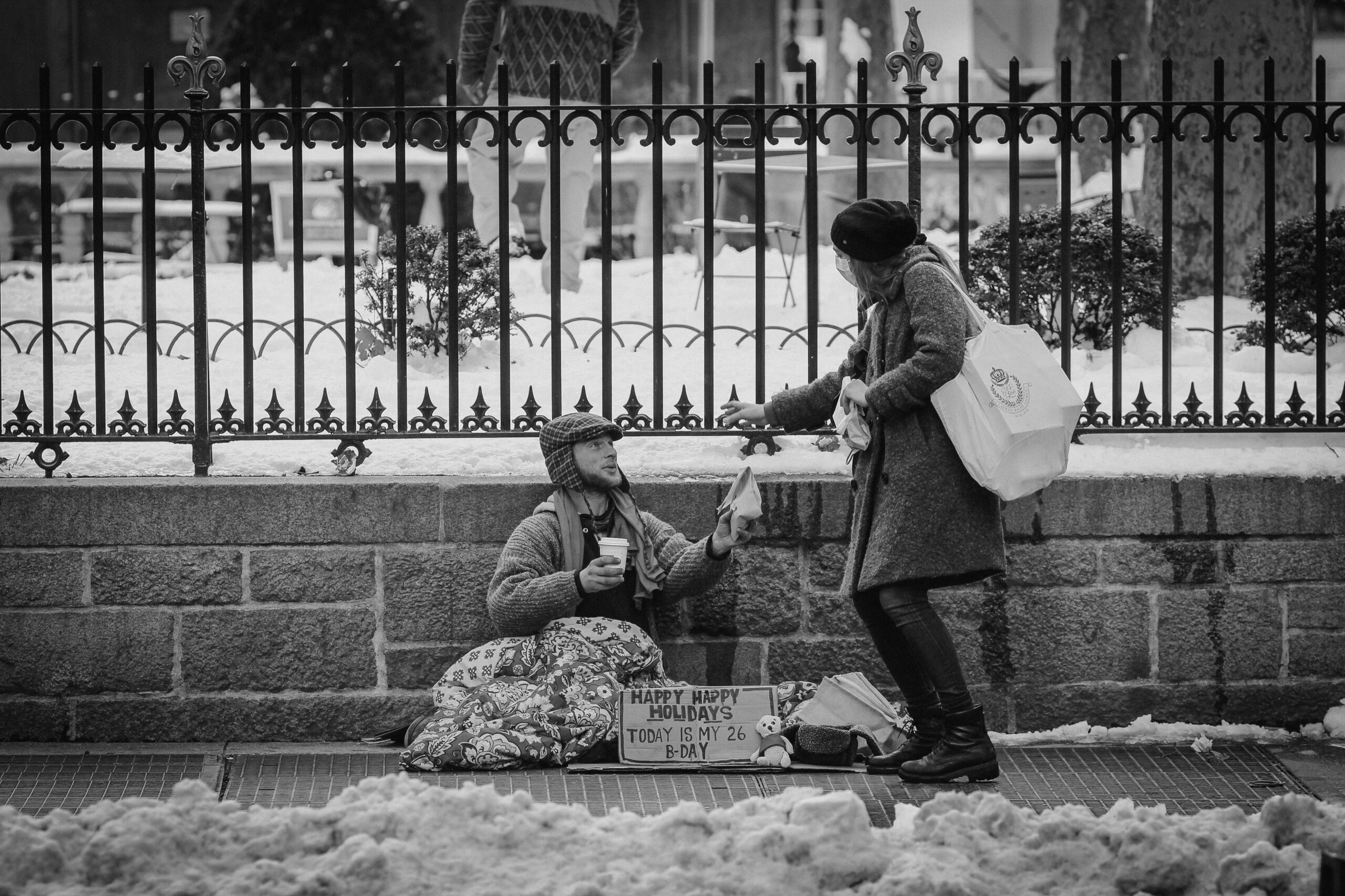 Homeless person being helped by a woman