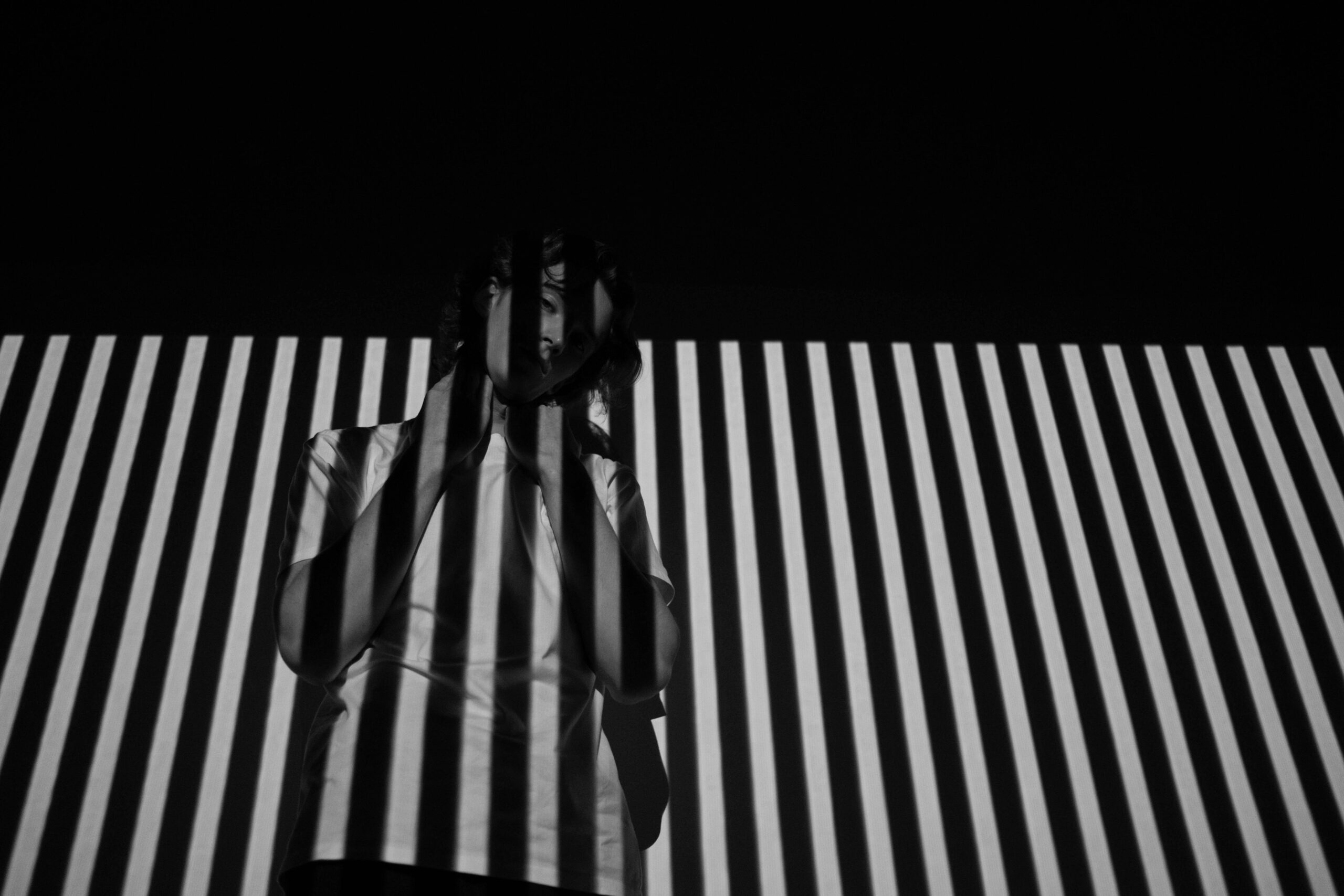 Person in white and black striped background