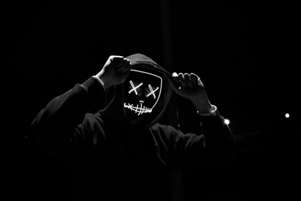 A man with a hoodie and a mask