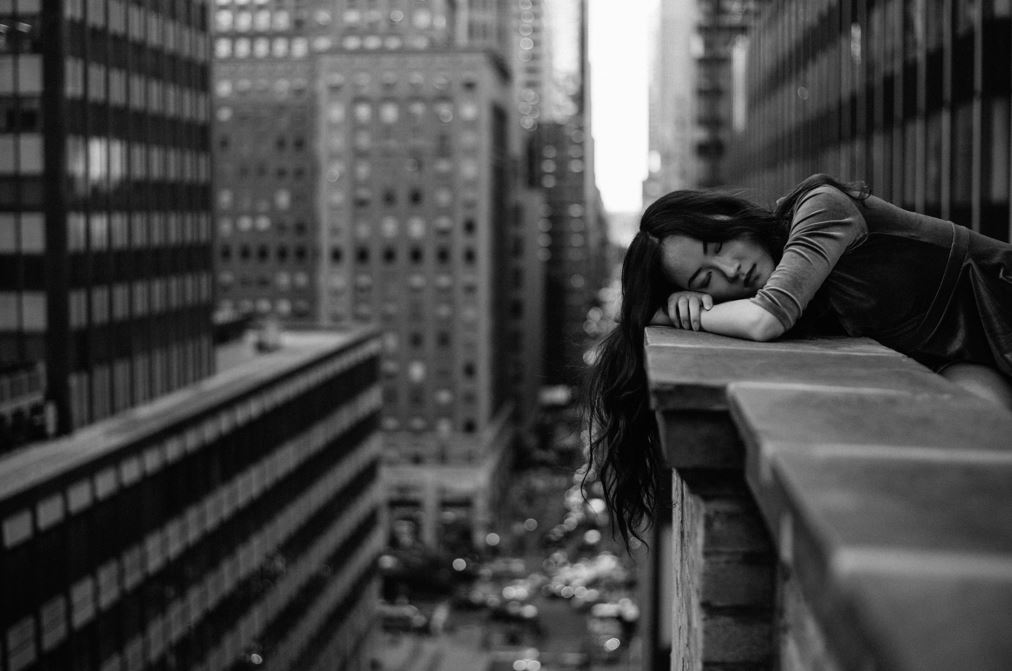 Woman leaning on a building's railing