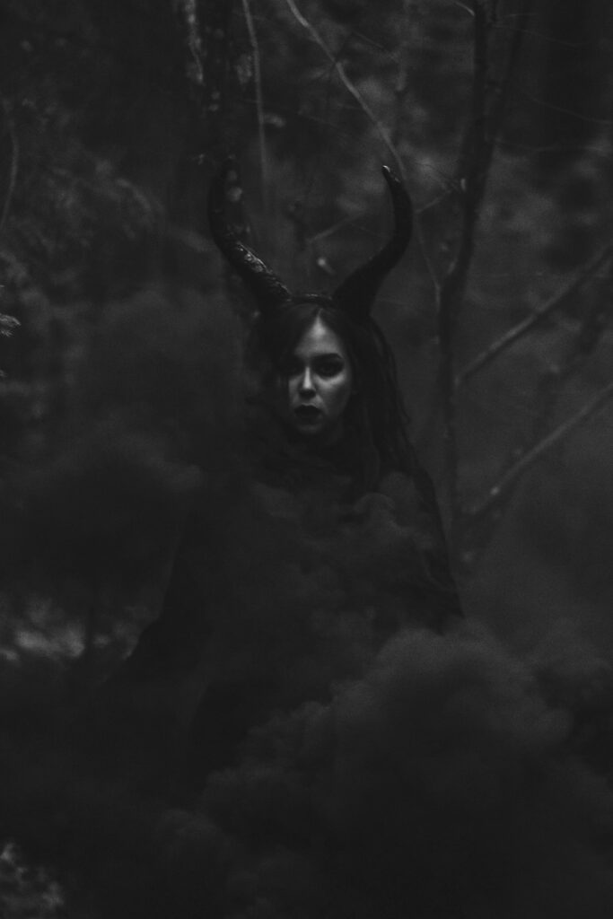 A woman with horns in the woods