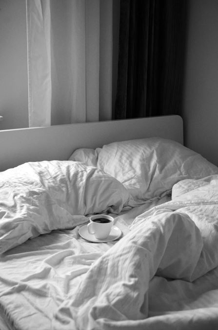 Coffee cup on a bed