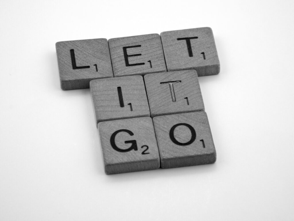 Scrabble tiles spelling "let it go"