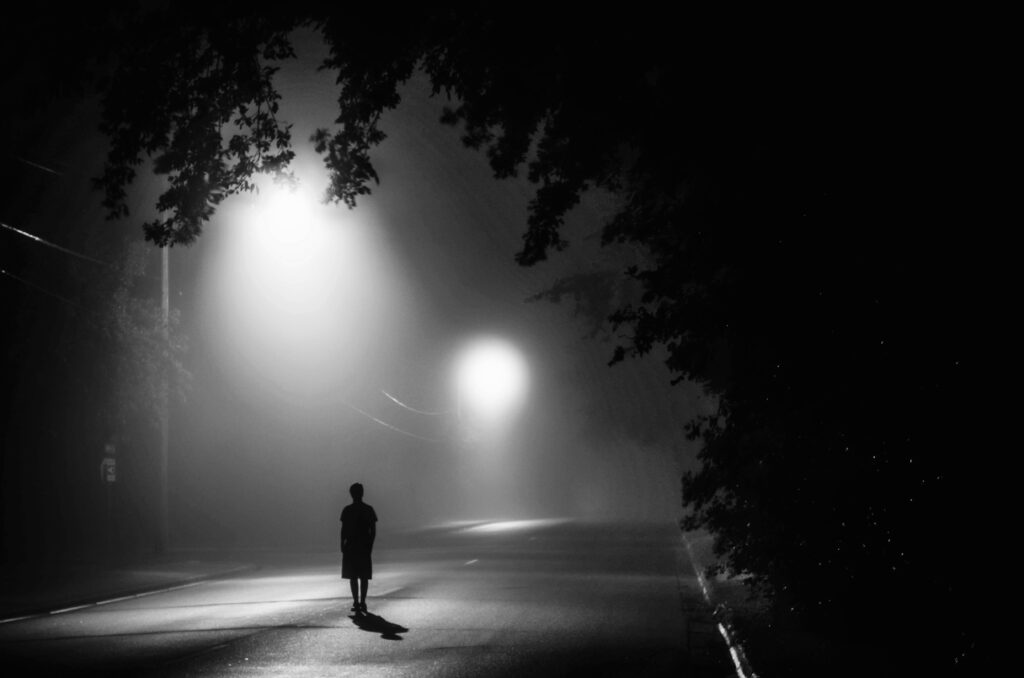 Silhouette of person standing on concrete road