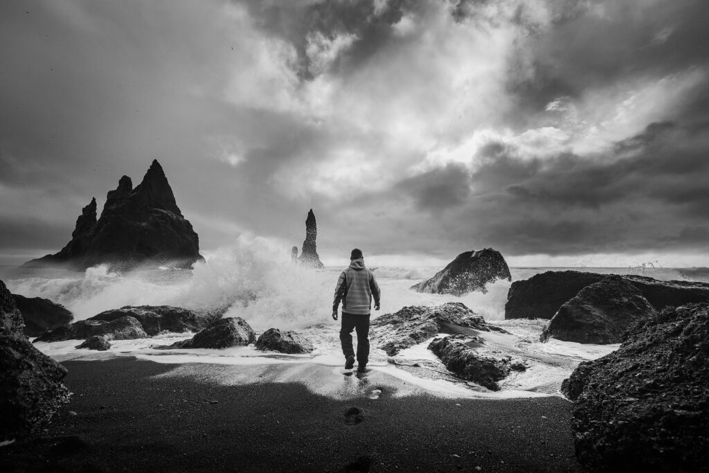 Man standing beside beach