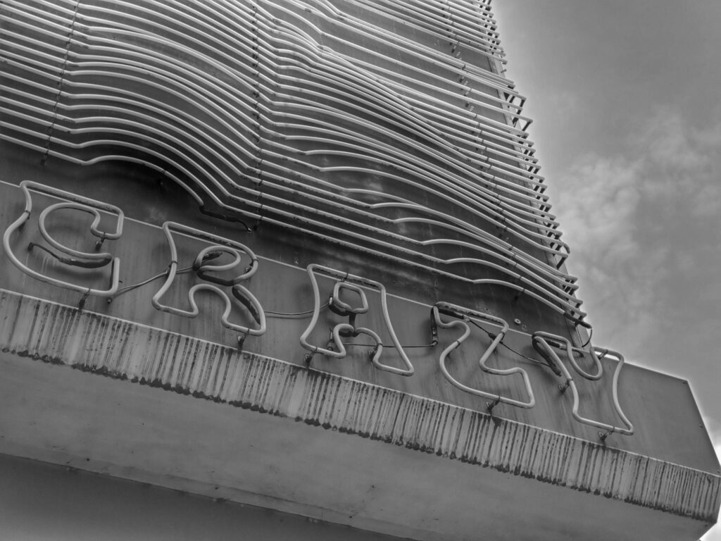 Concrete building with a sign "crazy"